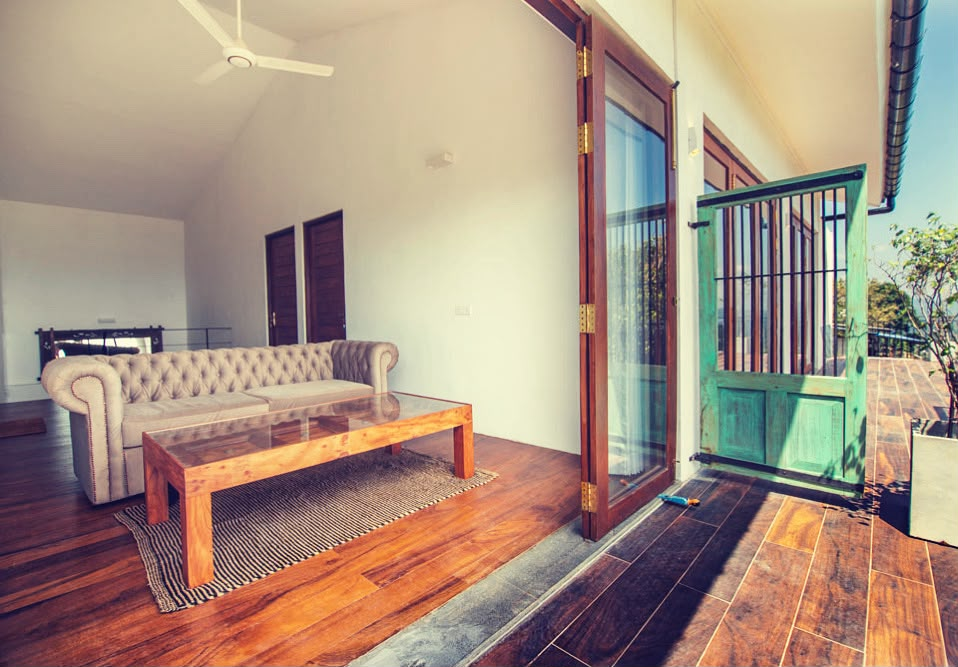 A sitting area at Kandy Casa opening onto the balcony