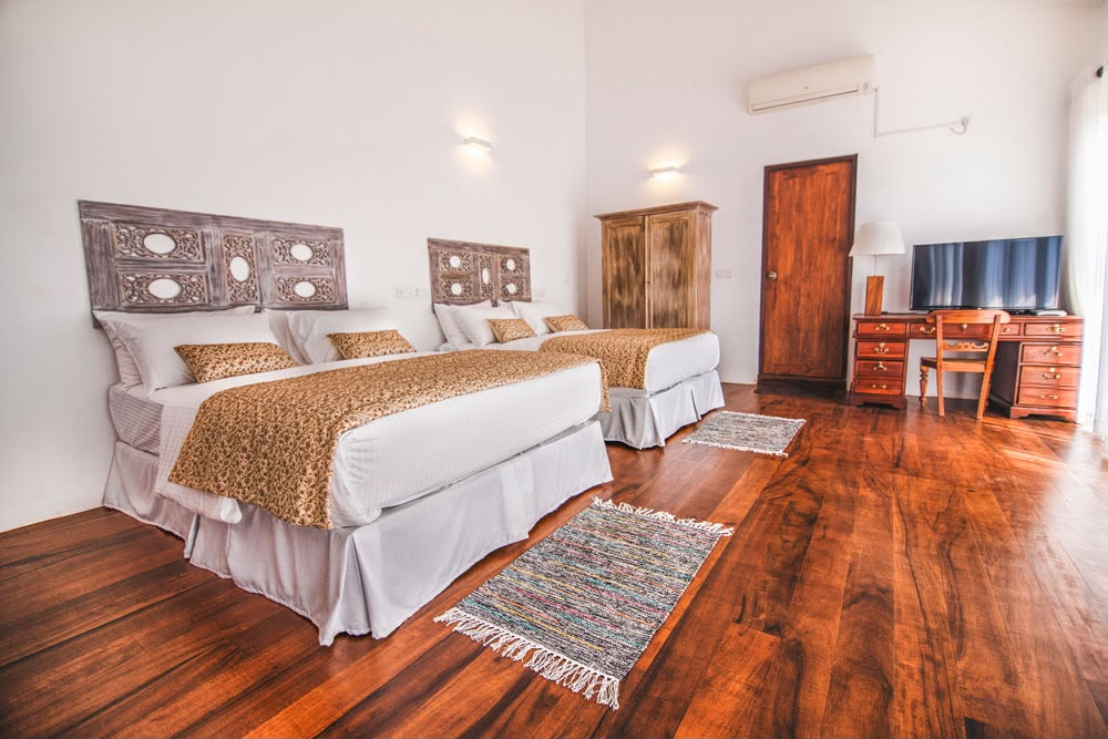 The two beds, desk and TV in the Superior Family Room at Kandy Casa