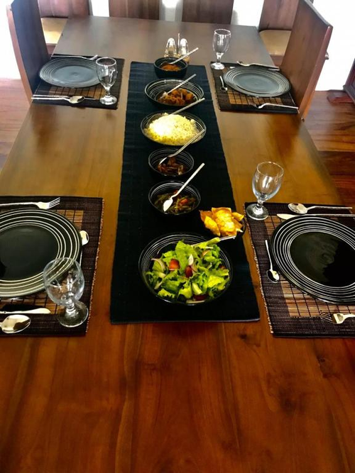 A table at Kandy Casa laid with rice, curries and a fresh salad