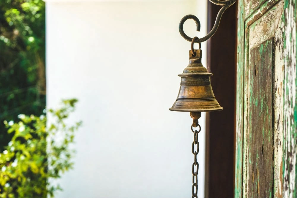 A brass bell hanging beside a doorway at Kandy Casa