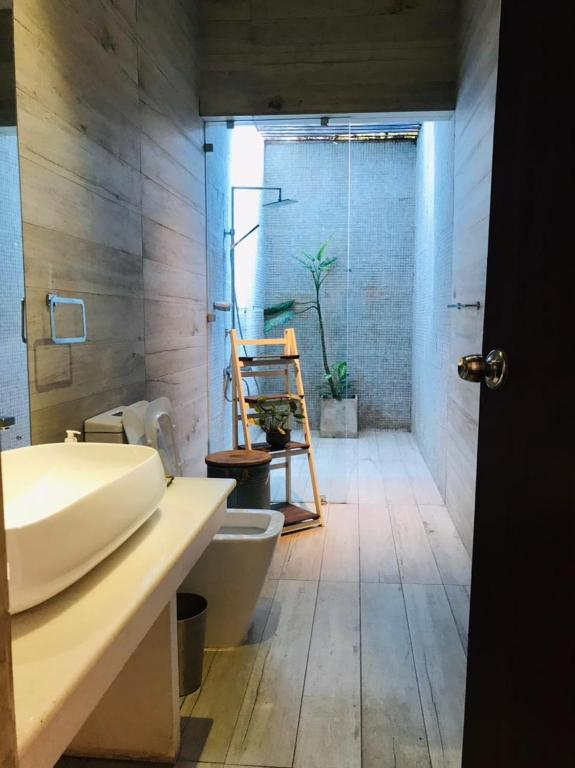 The bathroom of a Superior Double Room, with the hot water shower at the far end