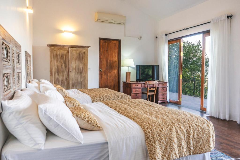 The Superior Family Room looking past the beds to the open balcony doors