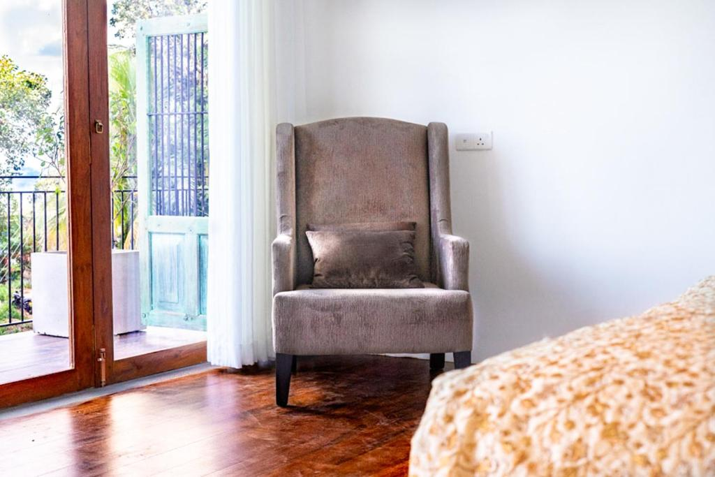 An armchair beside the balcony doors in the Superior Family Room