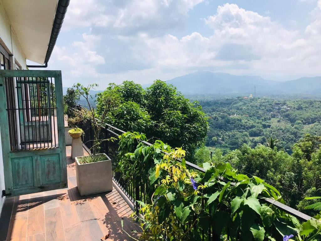 The balcony of the Superior King Room, looking over the trees to the mountains