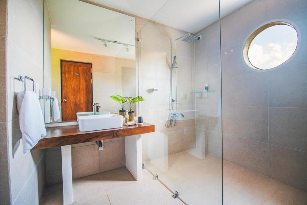 The basin and glass-screened hot water shower in the Superior King Room bathroom