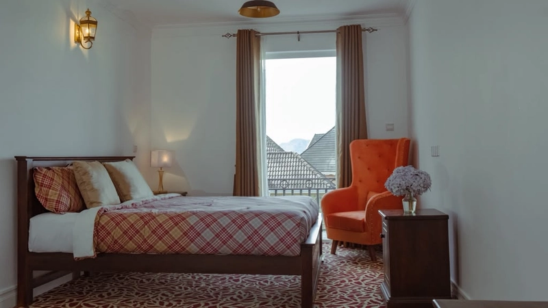 A Superior Double Room with an armchair beside the window