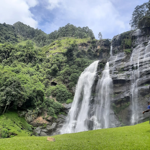 The white streams of Bomburu Ella Waterfall against a rock face