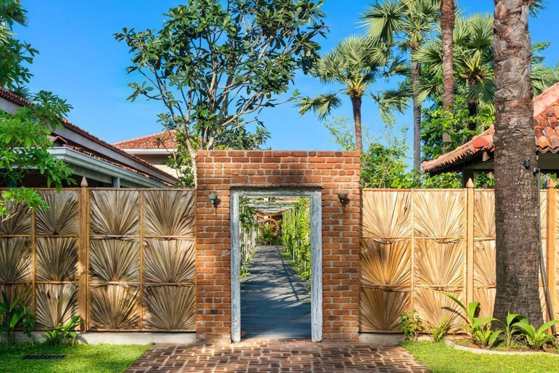 A brick gateway into the garden at Palmera Eco Resort