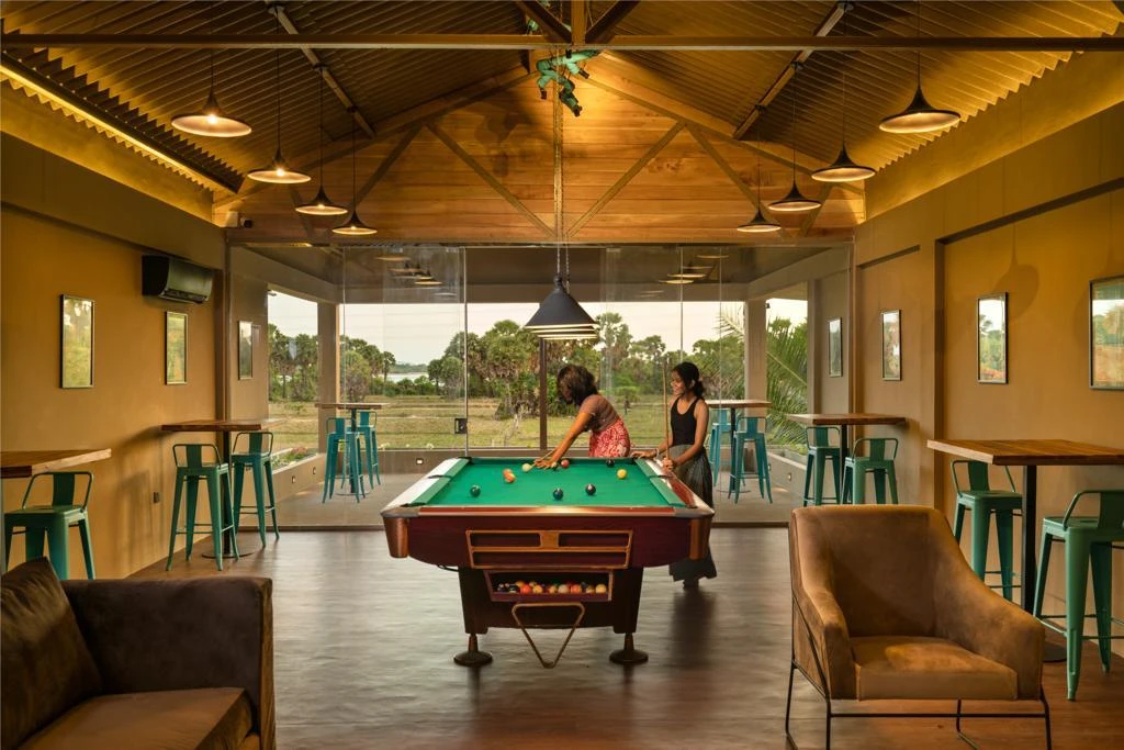 Guests playing pool in the open-sided games room