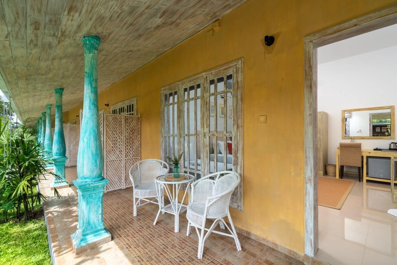 Chairs on a guest room verandah at Palmera Eco Resort