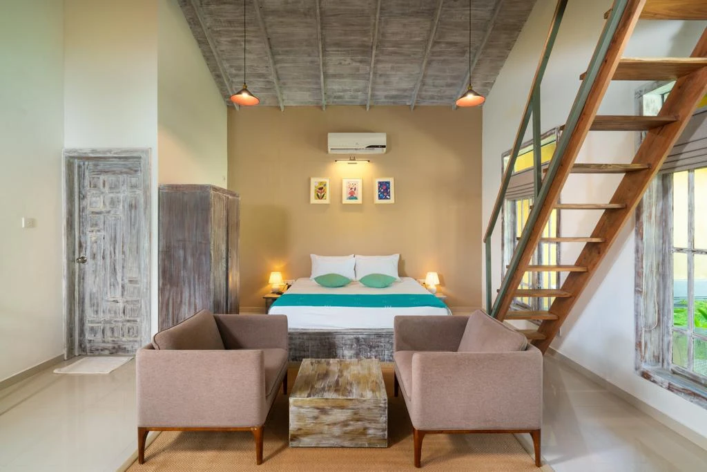 The king bed and sitting area of a Deluxe Family Chalet