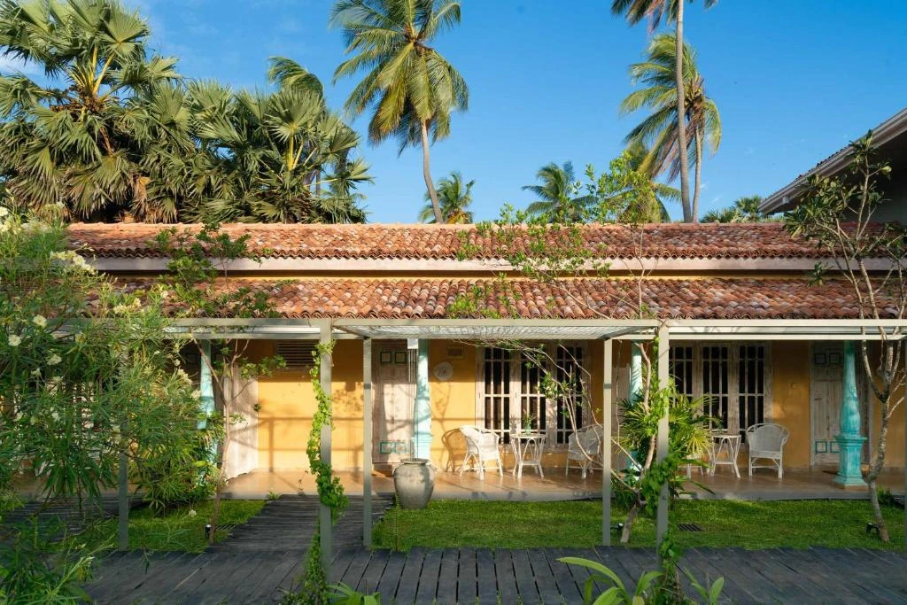 The guest rooms at Palmera Eco Resort behind a planted pergola