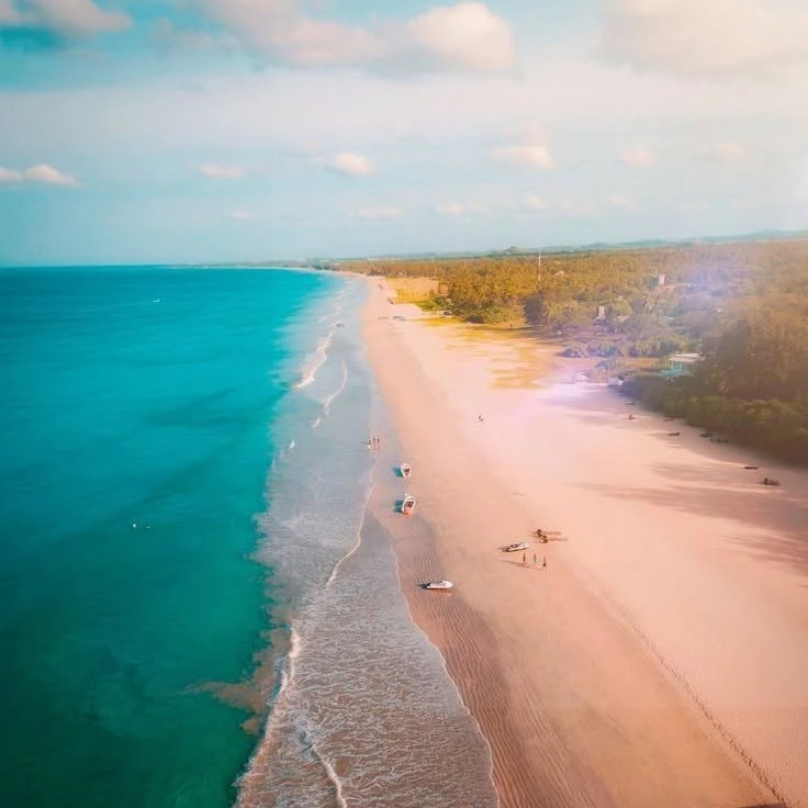 Nilaveli Beach from the air, pale sand running beside turquoise sea