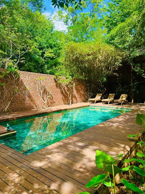 The tiled outdoor pool at Varanya with loungers on the timber deck