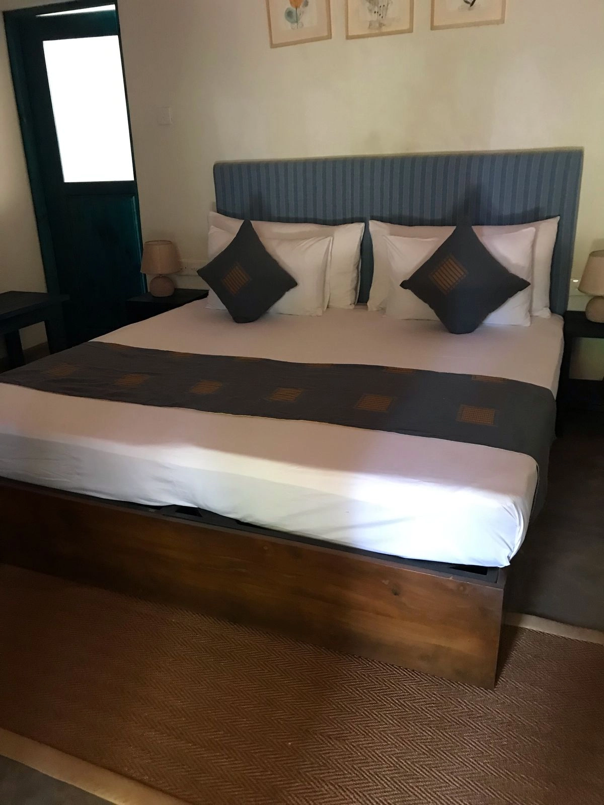The Double Room with Garden View beneath its padded headboard