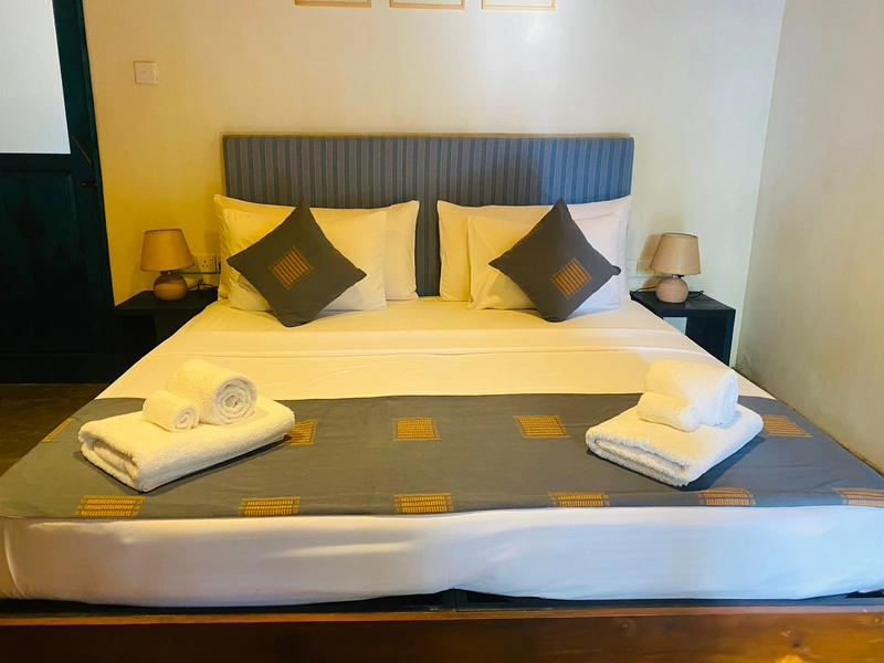 The bed in the Double Room with Garden View made up for arrival