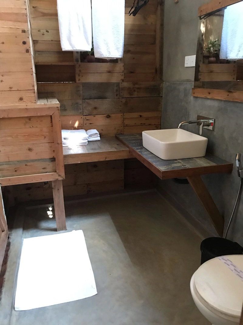 The basin in the timber bathroom of a Triple Room with Pool View