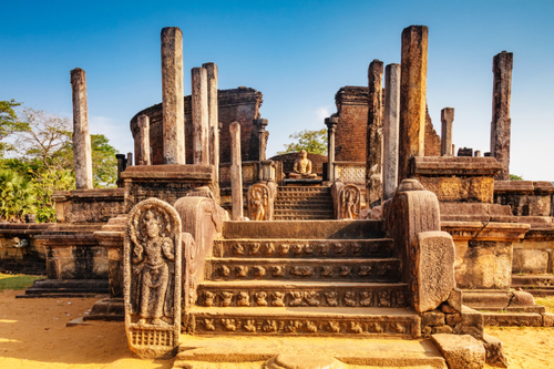 Carved guardstones and stone pillars at an ancient temple ruin in Polonnaruwa