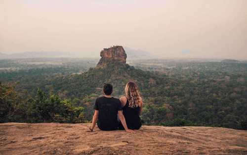 Two visitors on the summit of Pidurangala looking out at Sigiriya rock